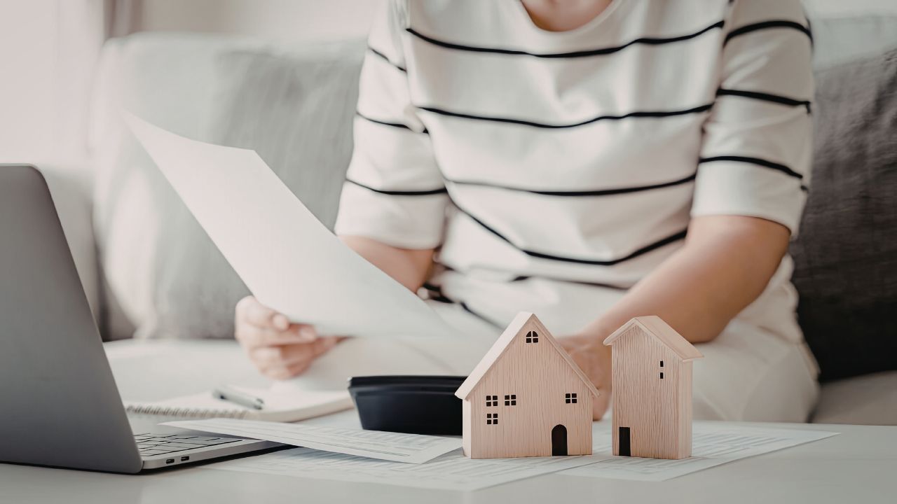 Property%20manager%20reviewing%20paperwork%20laptop Property%20manager%20reviewing%20paperwork%20laptop